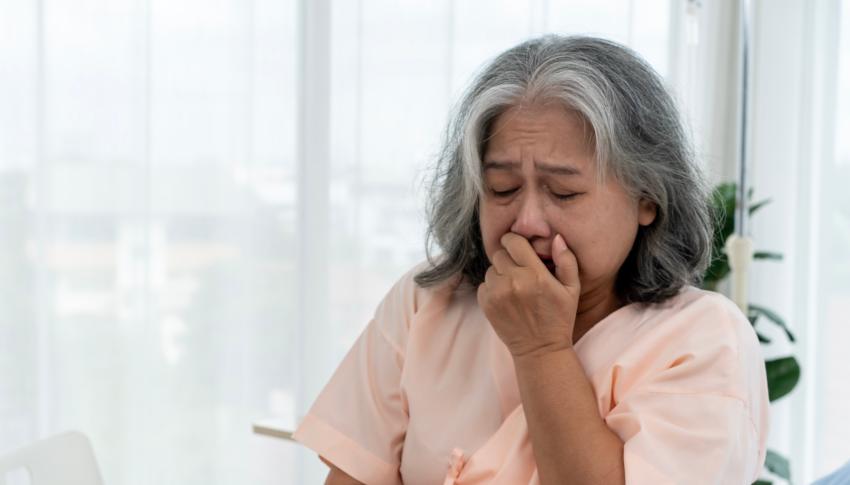 Older woman coughing with suspected COPD